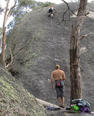 Climbers on "Deceit", 20m grade 14.