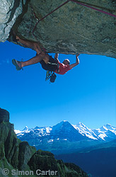 Tom Hoffman on pitch three of Spectacolo (7b, 160-metres) on Hintesberg, with the Eiger and the Monk mountains in the background, Switzerland.