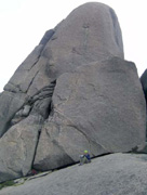 Nick ponders the guide at the base of The Catherdral. Maragrah climbs the weakness in the left side.