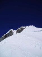 Looking up to the Mt Cook ice cap from the top of summit rocks. Notice Middle Peak on the left and the summit Chandelier on the right