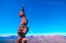 Monique Forestier atop the summit spire of Ancient Art  (5.11a) in the Fisher Towers, near Moab, Utah, USA. 